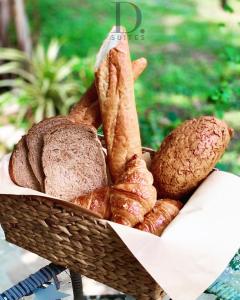 a basket filled with bread and croissants on a table at Boutique Garden Hotel in Ho Chi Minh City