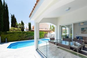 a villa with a swimming pool and a house at Bungalow Mikaella by Ezoria Villas in Coral Bay