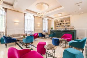 a waiting room with colorful chairs and tables at BO Hotel Palazzo in Poreč
