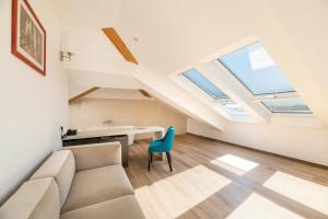 a living room with a couch and a desk at BO Hotel Palazzo in Poreč
