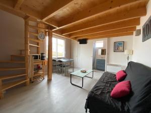 a living room with a couch and a table at CENTRE CHATELAILLON GRAND LOFT ** 100m DE LA PLAGE in Châtelaillon-Plage
