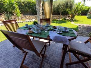 a table with food on it on a patio at Villa Cruccuris in Villasimius