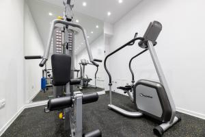 a gym with two tread machines in a room at BO Hotel Palazzo in Poreč