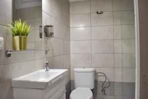 a bathroom with a toilet and a sink at Check Point - Acropolis in Athens +23 photos
