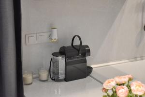 a counter top with a coffee maker and candles at Check Point - Acropolis in Athens