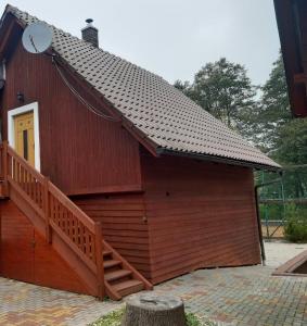 a small building with a staircase on the side of it at Apartmány Jarmila in Dolní Moravice