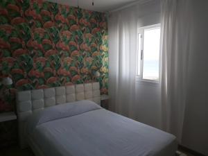 a bedroom with a bed with a floral wallpaper at Alexia Beach in Playa Honda +31 photos