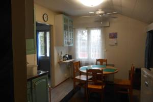 a kitchen and dining room with a table and chairs at Perniön Majoitus 6 in Perniö