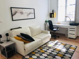 a living room with a white couch and a desk at Big Bright New Apt next to Casino in Monte Carlo