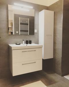 a bathroom with a white sink and a mirror at Big Bright New Apt next to Casino in Monte Carlo