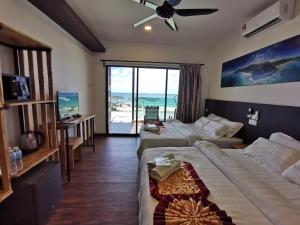 ein Hotelzimmer mit 2 Betten und Strandblick in der Unterkunft The Barat Tioman Beach Resort in Kampong Juara