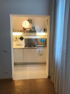 a kitchen with white cabinets and a stove top oven at Appartamento Ghetto Novissimo in Venice