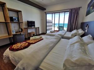 Ein Bett oder Betten in einem Zimmer der Unterkunft The Barat Tioman Beach Resort
