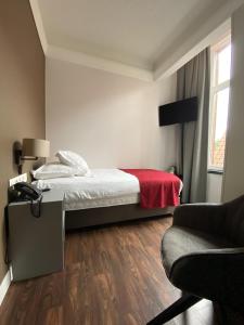 Ένα ή περισσότερα κρεβάτια σε δωμάτιο στο Hotel New Regina