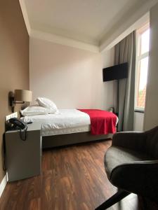 Ένα ή περισσότερα κρεβάτια σε δωμάτιο στο Hotel New Regina