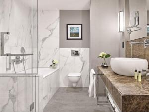 a bathroom with a tub and a sink and a toilet at InterContinental Sofia by IHG in Sofia