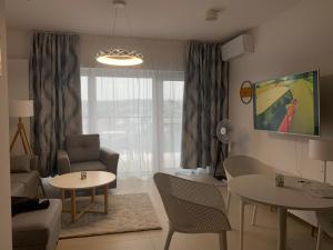 a living room with a couch and a table and chairs at Aquamarina Prima Exclusive Suites in Międzyzdroje