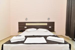 a bedroom with a bed with white towels on it at Hotel Bella Vista in Eforie Nord
