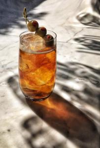 a drink with olives in a glass on a table at A for Athens in Athens