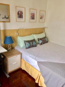 a bedroom with two beds and a lamp on a table at Budget Double Room in Kepong