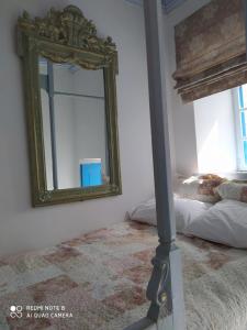 a mirror on a wall next to a bed at Villa Evdokia Kasos in Agía Marína