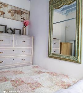 a bedroom with a dresser and a mirror at Villa Evdokia Kasos in Agía Marína