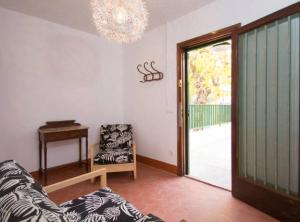 een woonkamer met een bank, een stoel en een raam bij Salou 2 · House2 garden in front of the beach - Ferrari Land in Salou
