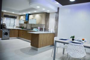 a kitchen with a counter and a table and chairs at Dar lotfi in Houmt Souk