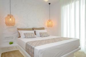Postel nebo postele na pokoji v ubytování Naxian Spirit Inn