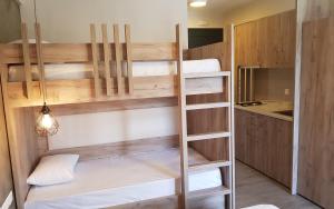 a room with wooden bunk beds in a kitchen at Sarti Holidays in Sarti
