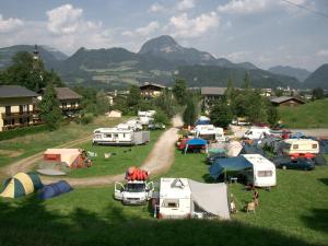 a group of tents in a field with mountains in the background at Campingplatz Torrenerhof in Golling an der Salzach