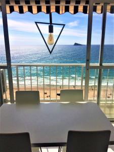 a conference room with a table and a view of the beach at Apartamentos Altea Darsena - Family Apartments in Benidorm