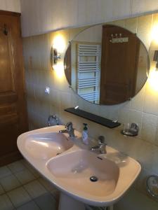 a bathroom with a sink and a mirror at Venasque Vue Apartment in Saint-Mamet