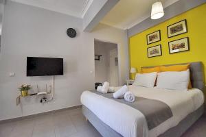 a bedroom with a large bed and a tv at Check Point - Acropolis in Athens