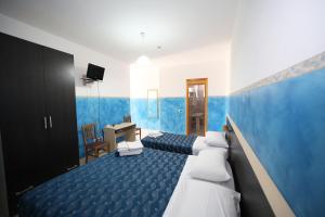 Postel nebo postele na pokoji v ubytování Hotel Napoleone