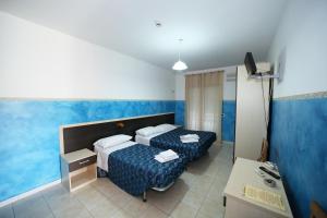 Postel nebo postele na pokoji v ubytování Hotel Napoleone