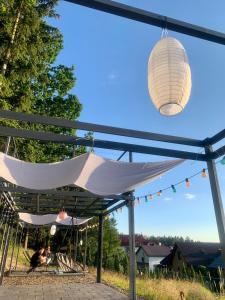 a hammock hanging from awning with a light fixture at Willa Zdrój in Kudowa-Zdrój