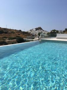a large swimming pool with blue water at Ios Sea View in Ios Chora