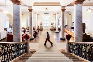 a man walks through the lobby of a hotel at Maloja Palace Suites CO2-Neutral in Maloja