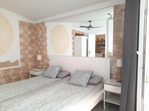 a bedroom with two beds and a mirror at Bungalow 2-7 Playa del Ingles in Playa del Ingles +31 photos