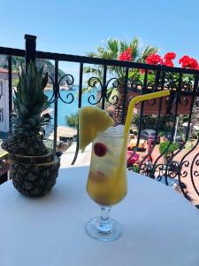 a drink sitting on a table next to a pineapple at Sardinia Otel in Amasra