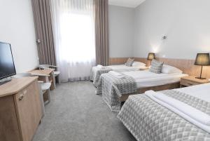 Postel nebo postele na pokoji v ubytování Hotel Jan Sander