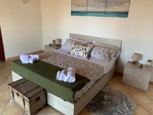 a bedroom with a bed with towels and shoes on it at Villa Mimma in Taormina +40 photos
