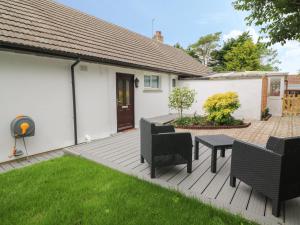 a deck with chairs and a table in a yard at Little Valley View in Hayle