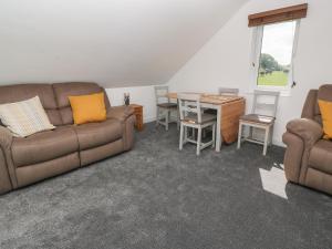 a living room with a couch and a table at Little Valley View in Hayle