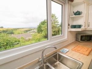 a kitchen with a sink and a window at Little Valley View in Hayle