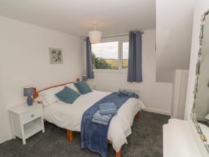 a bedroom with a bed and a window at Little Valley View in Hayle