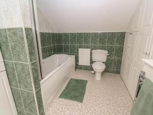 a bathroom with a toilet and a tub and a sink at Little Valley View in Hayle +19 photos