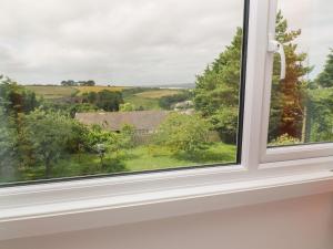 a window with a view of the countryside at Little Valley View in Hayle