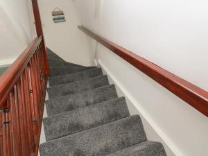 a staircase in a house with a stair case at Little Valley View in Hayle